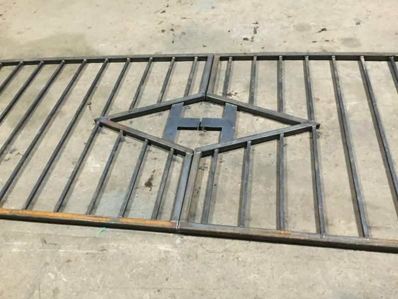 a metal gate with the letter h on it