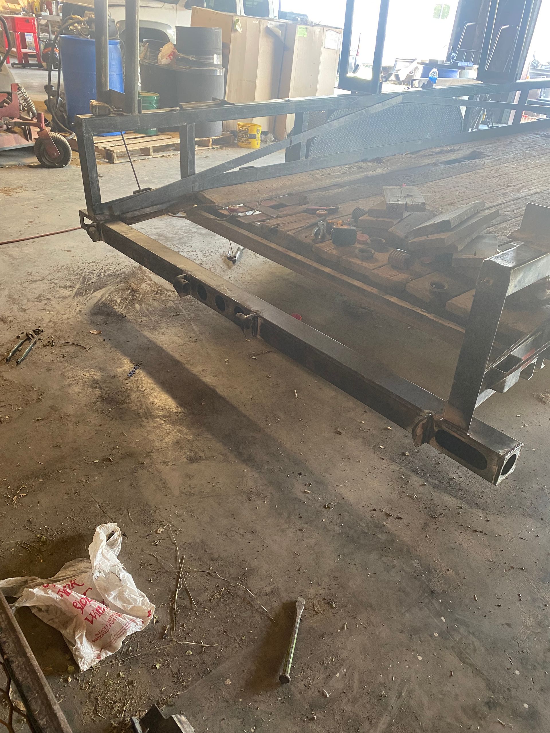 a piece of metal is sitting on the floor in a garage .