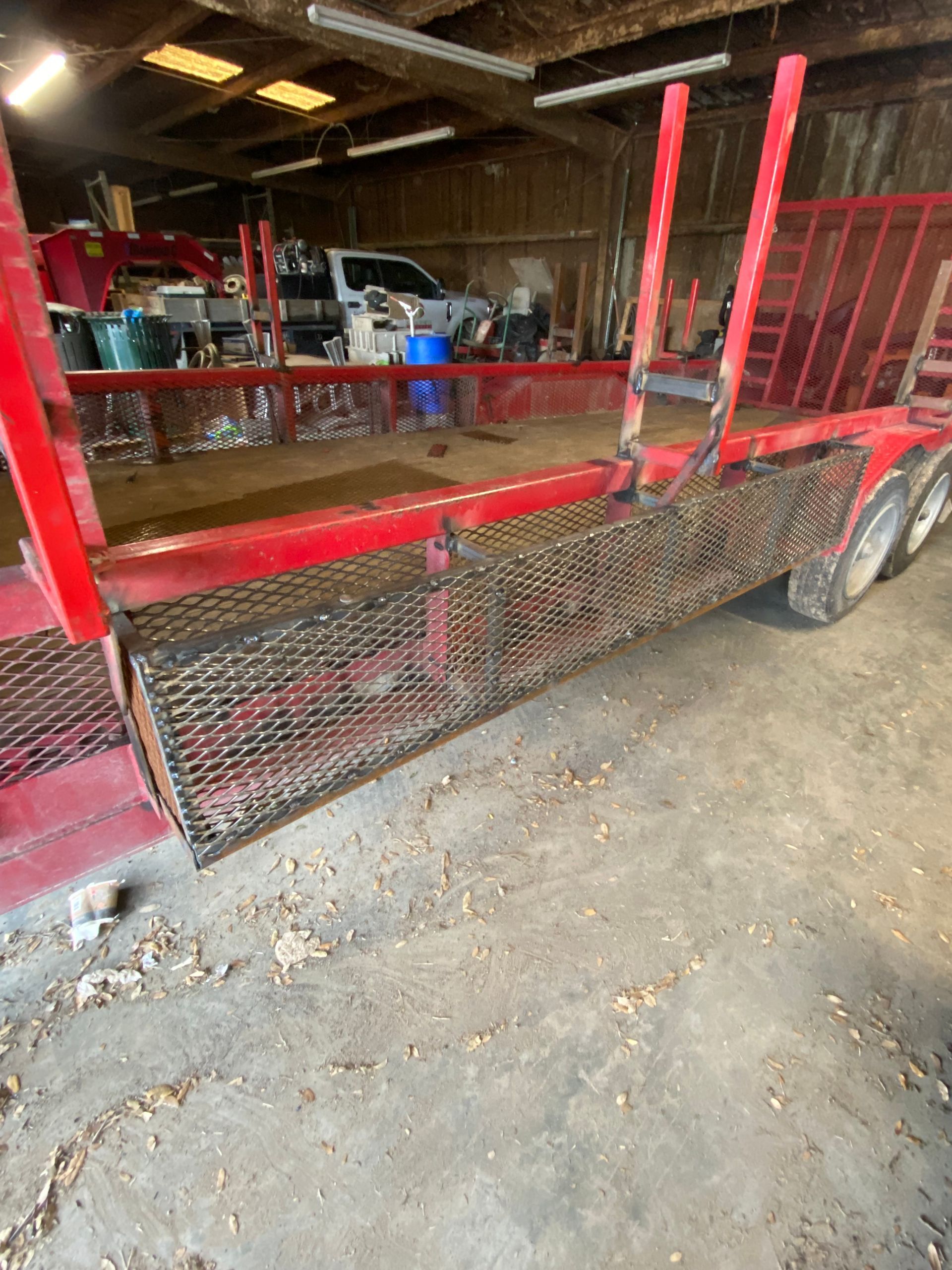 a red trailer is parked in a garage .