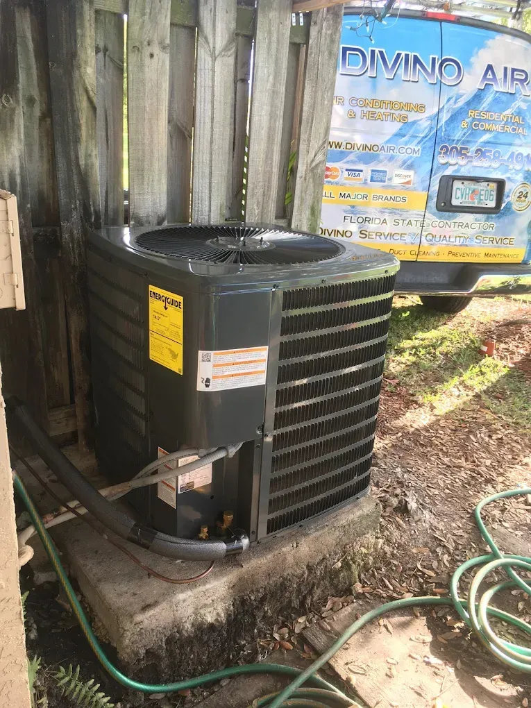 AC unit outside near a wooden fence, with the 