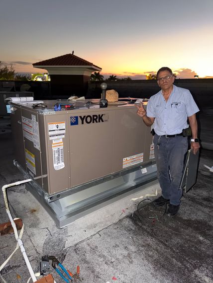 HVAC unit in a closet with white louvered doors, white pipes, and a blue wall.