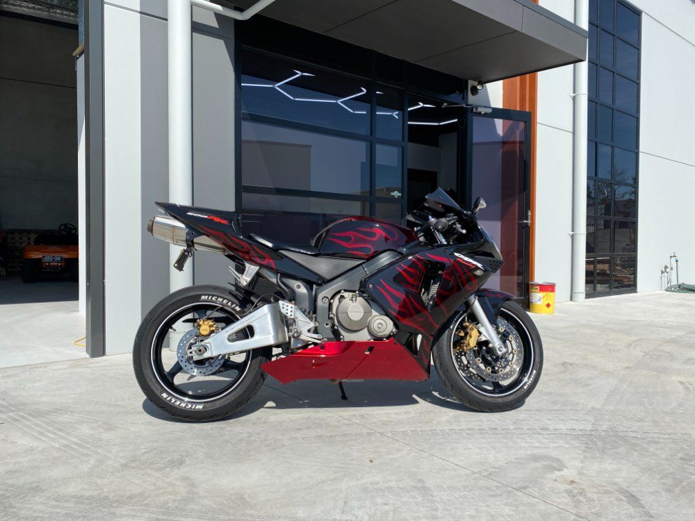 Red Sports Bike With Flame Sticker — Protective Coating in Cameron Park, NSW