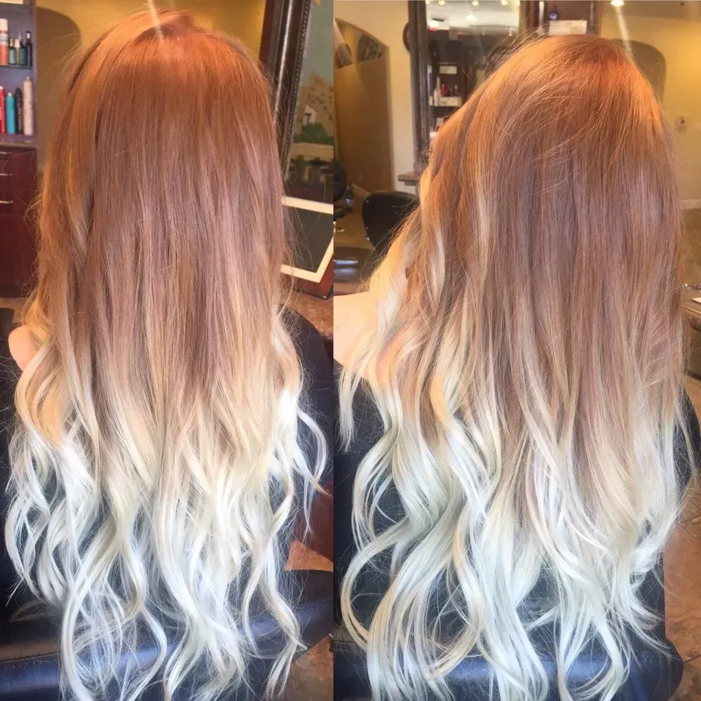 A woman with long blonde hair is sitting in a chair