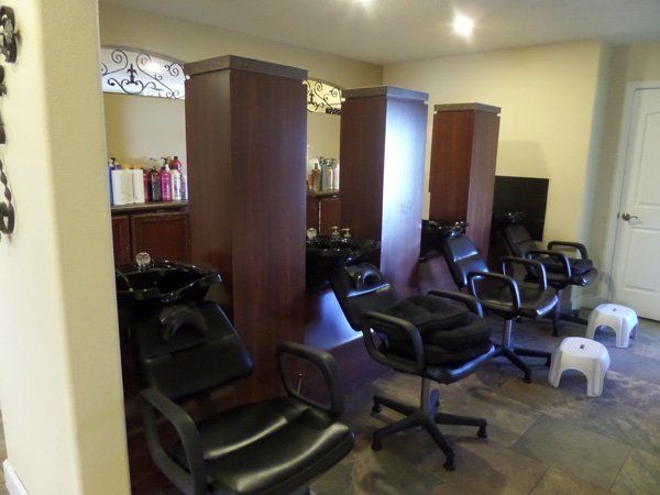 A salon with a lot of chairs and a sink