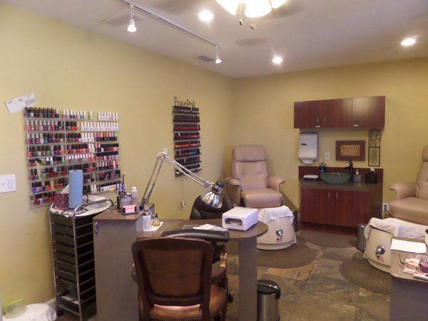 A nail salon with a chair and a table