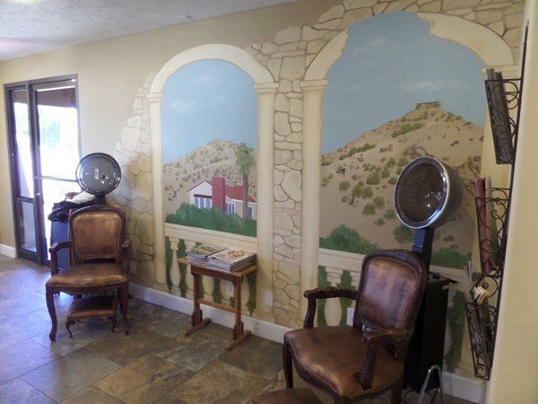 A room with chairs and a painting on the wall