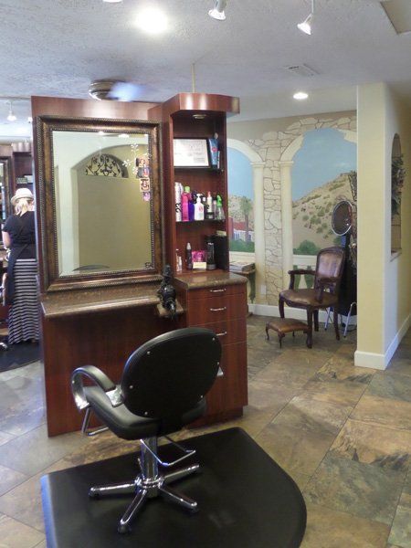 A hair salon with a chair and a mirror