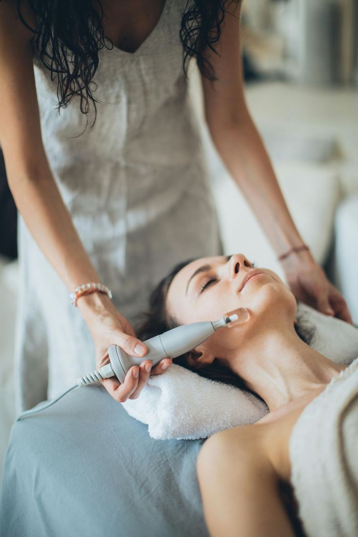 A woman is getting her hair dyed in a salon.