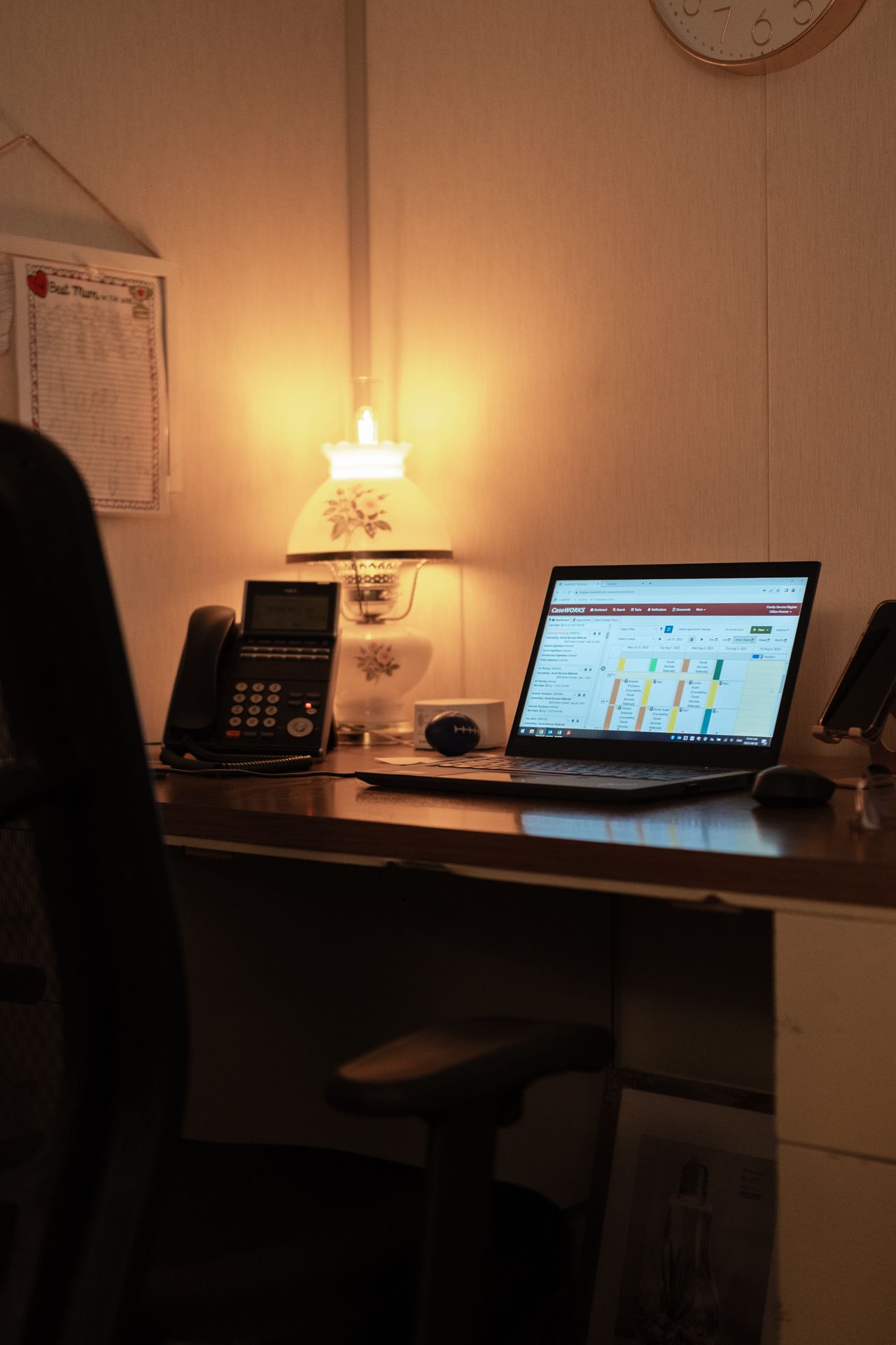 A desk with a laptop and a phone on it
