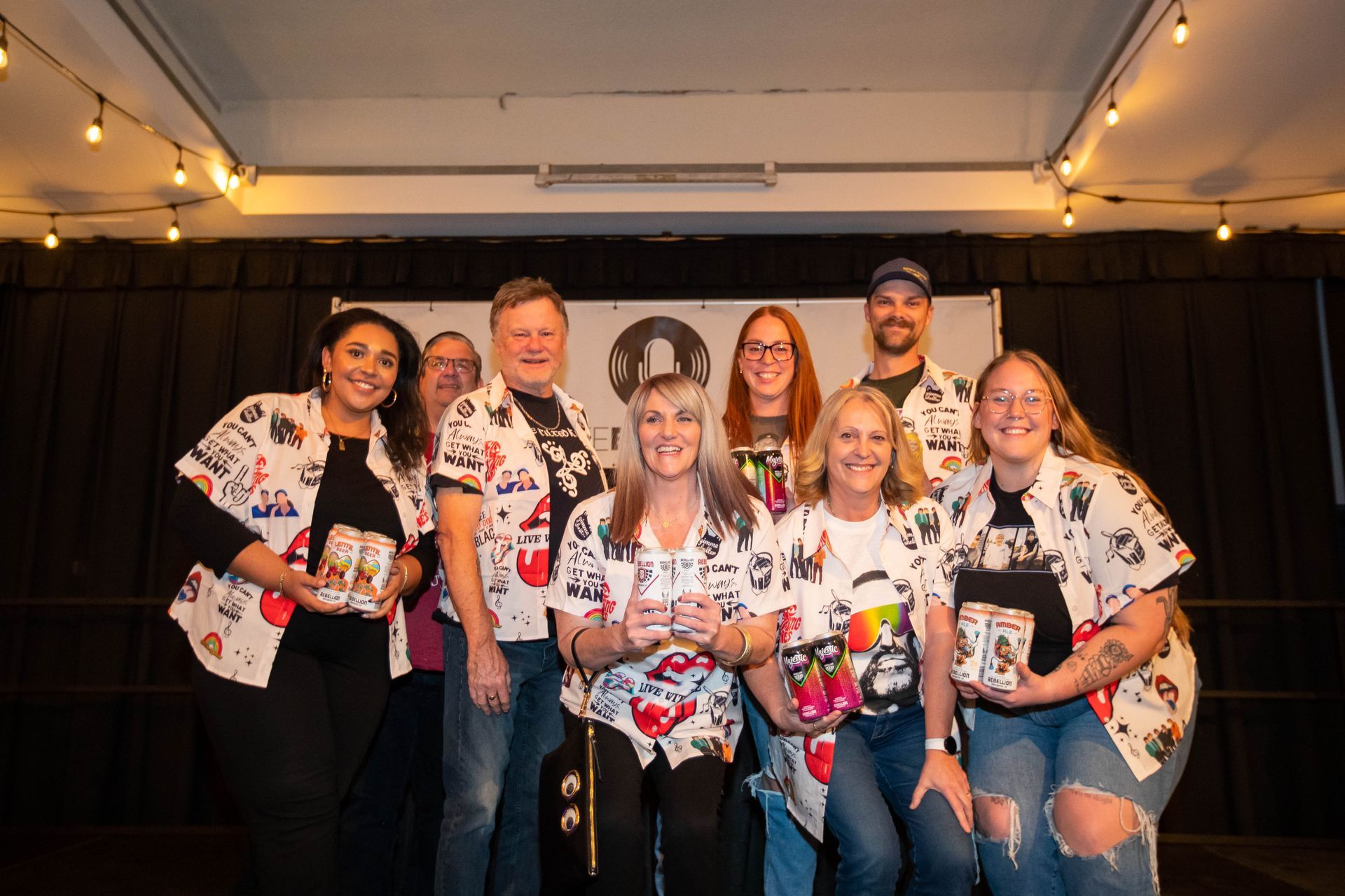 A group of people are posing for a picture on a stage.