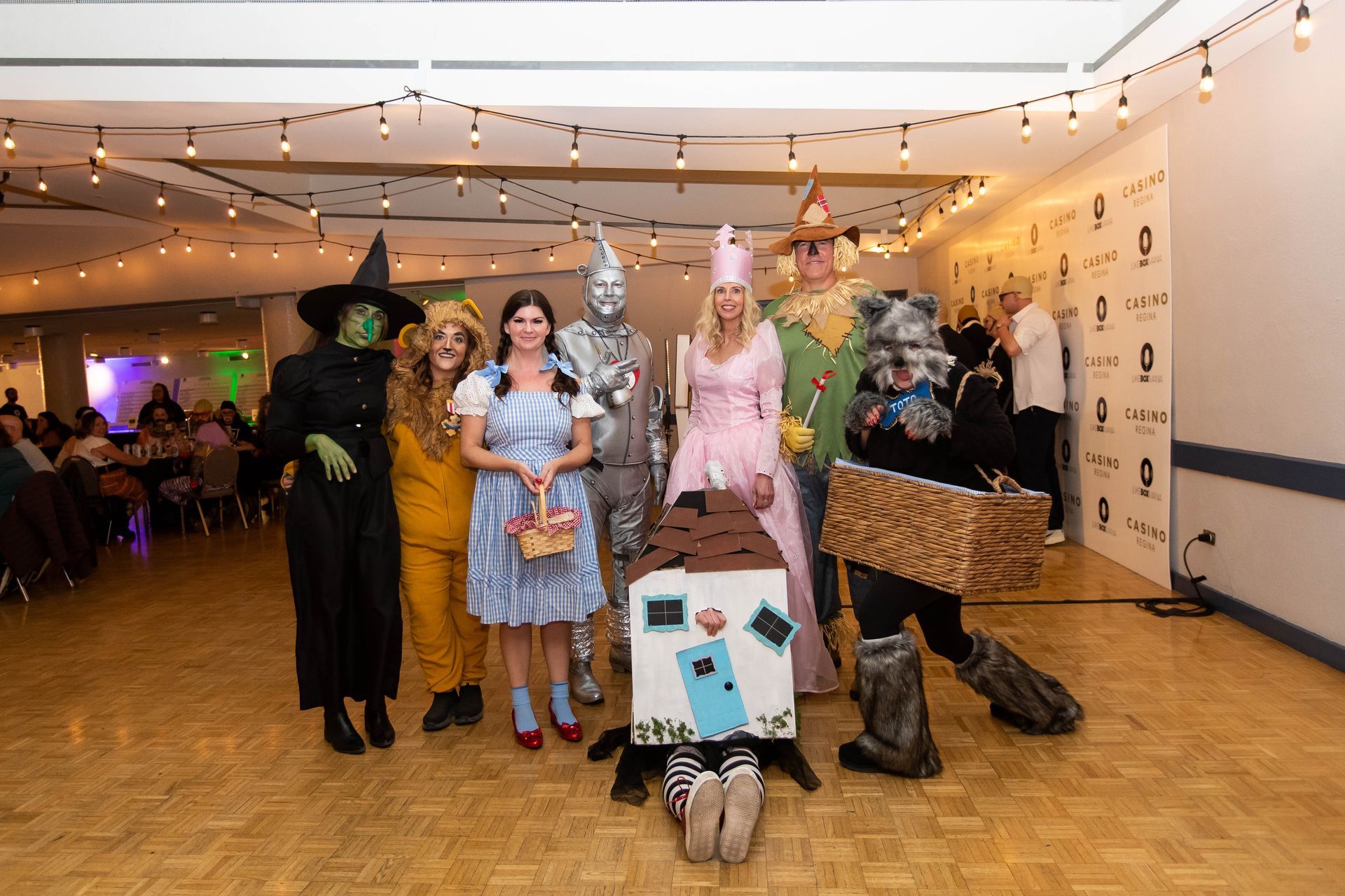 A group of people dressed in costumes are posing for a picture.
