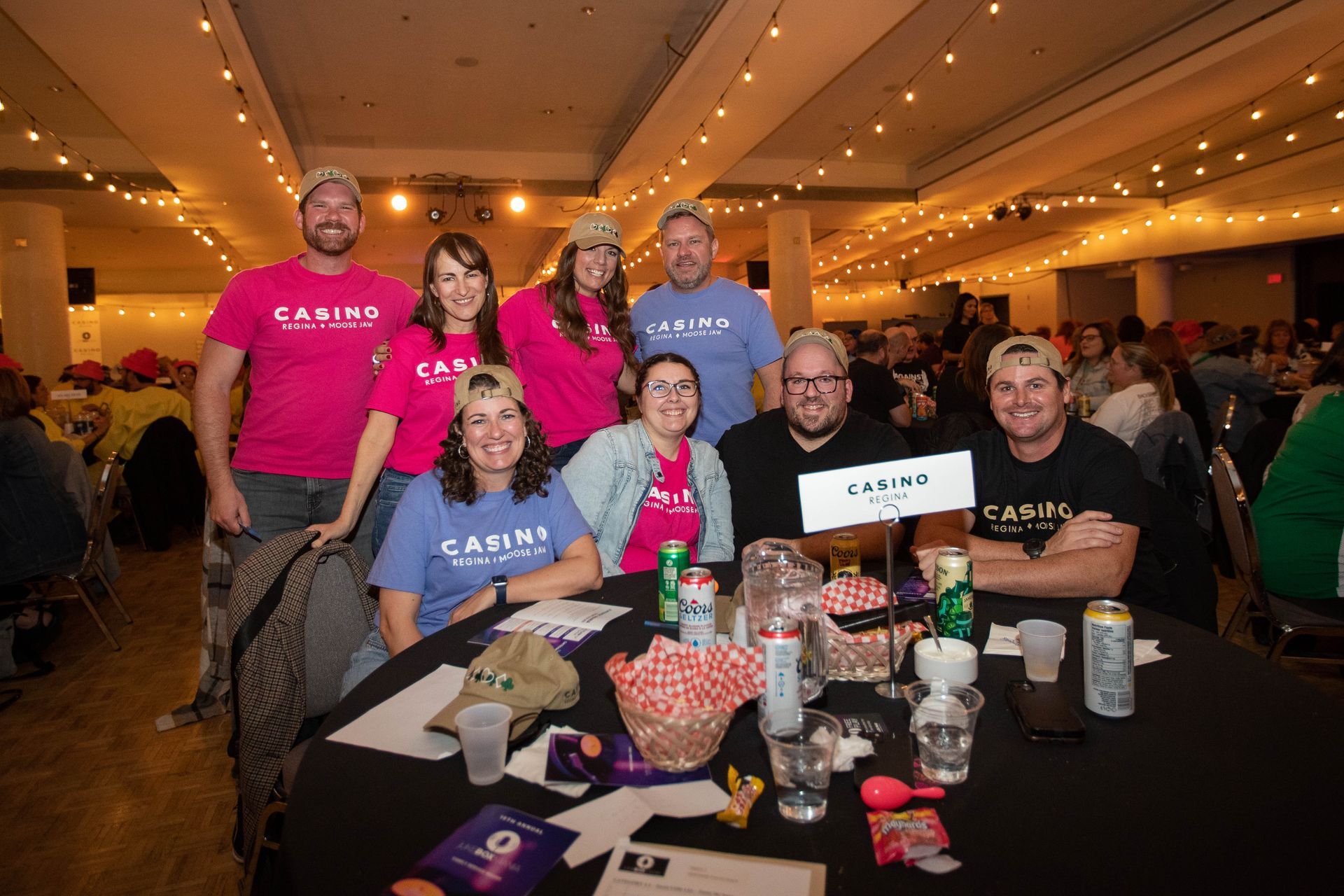 A group of people are sitting at a table in a room.
