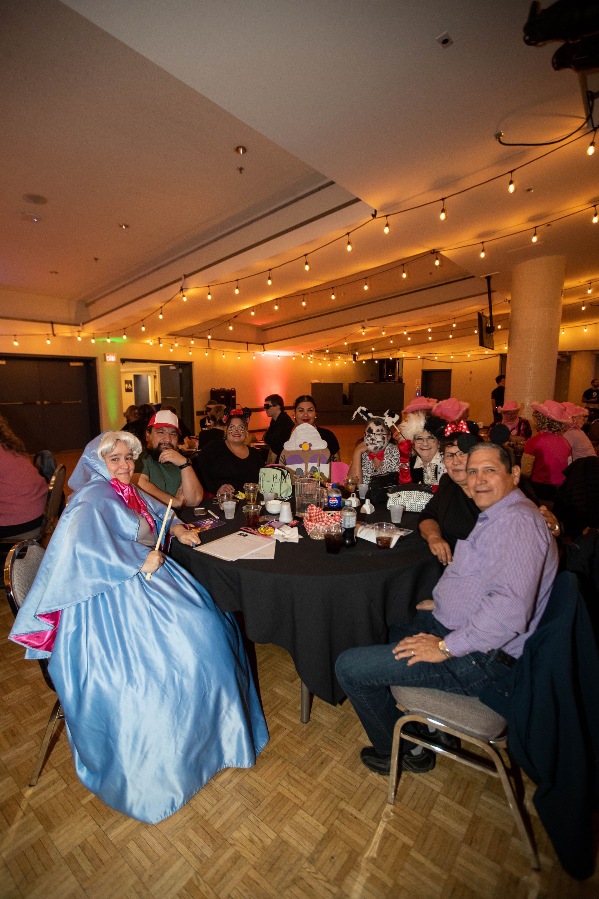 A group of people are sitting around a table in a room.