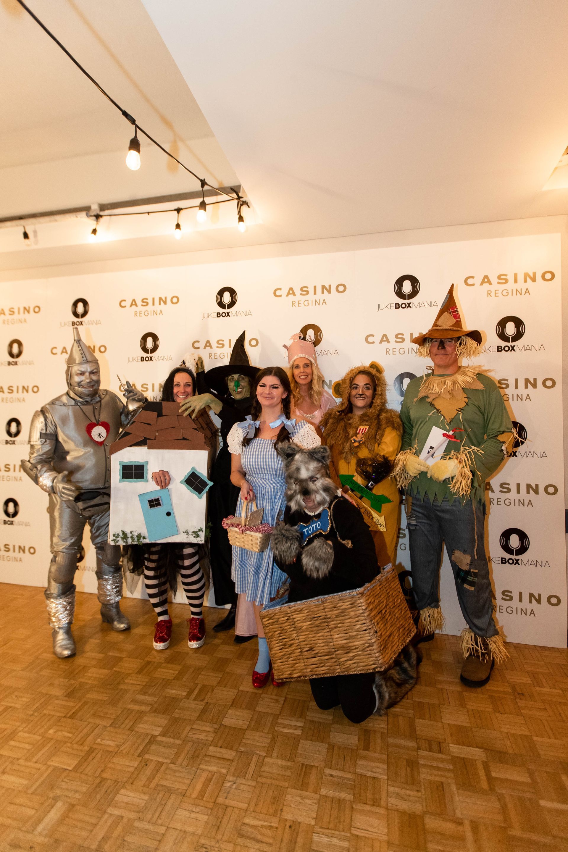 A group of people dressed in wizard of oz costumes are posing for a picture.