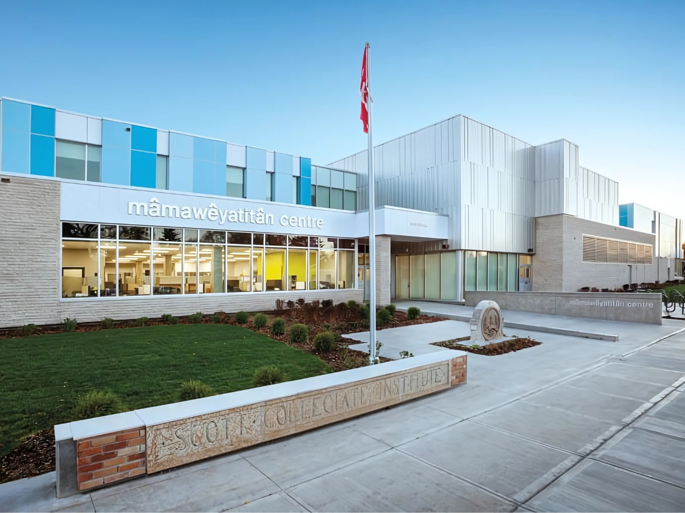 A large building with a lot of windows and a yellow line on the sidewalk.