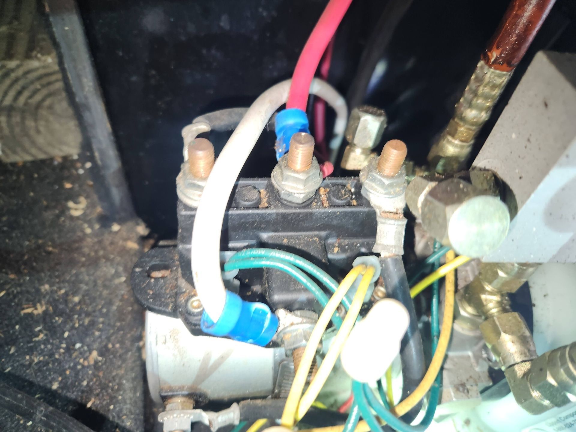 Close-up of electrical relay wiring with red, white, blue, and yellow wires inside a panel.