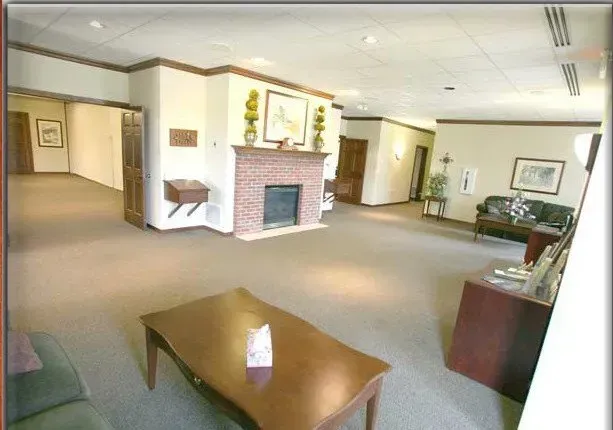 A living room with a fireplace and a coffee table