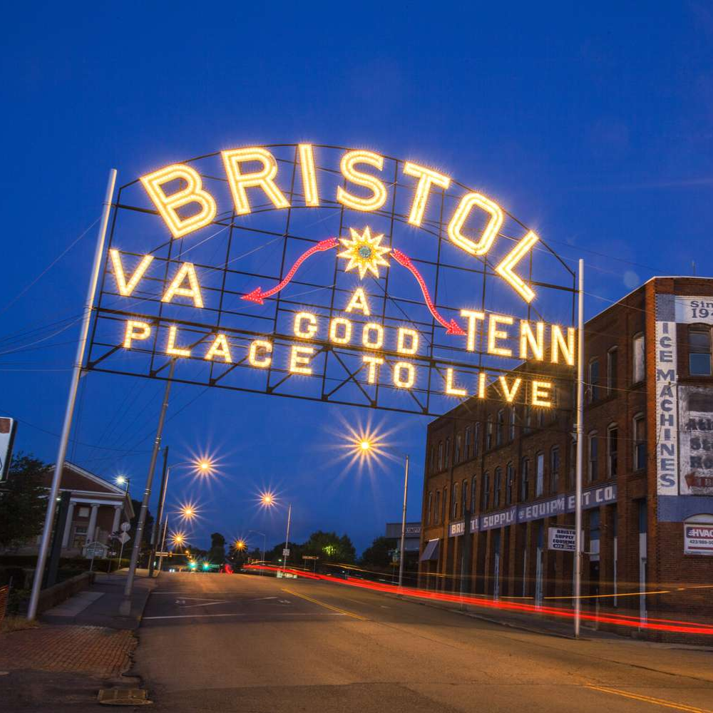 A lit up sign over State Street in Bristol that says Bristol, TN/VA