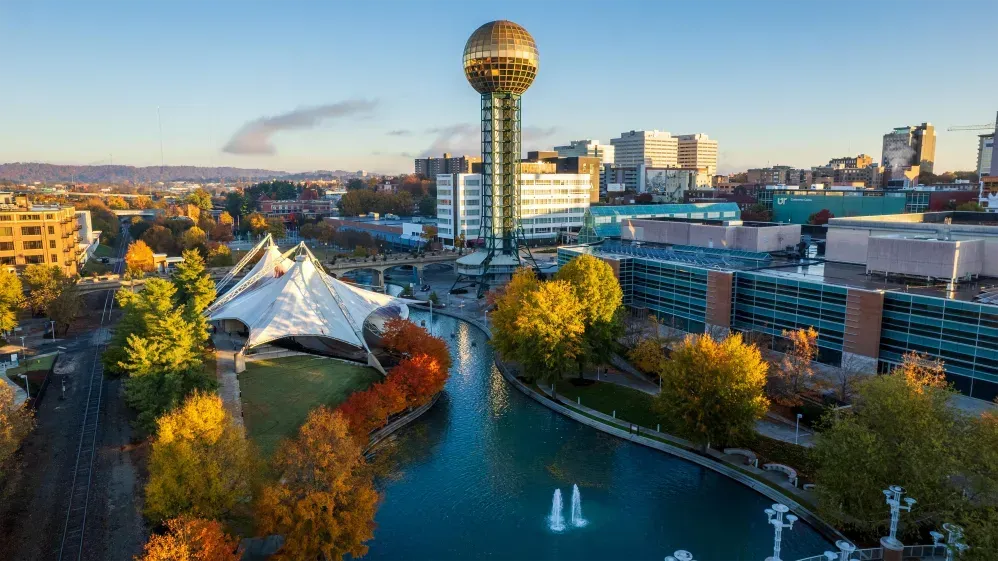 Aerial shot of Downtown Knoxville Tennessee with the gold World Fair Tower Ball rising above the town