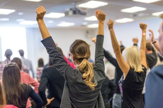 woman raising their hand