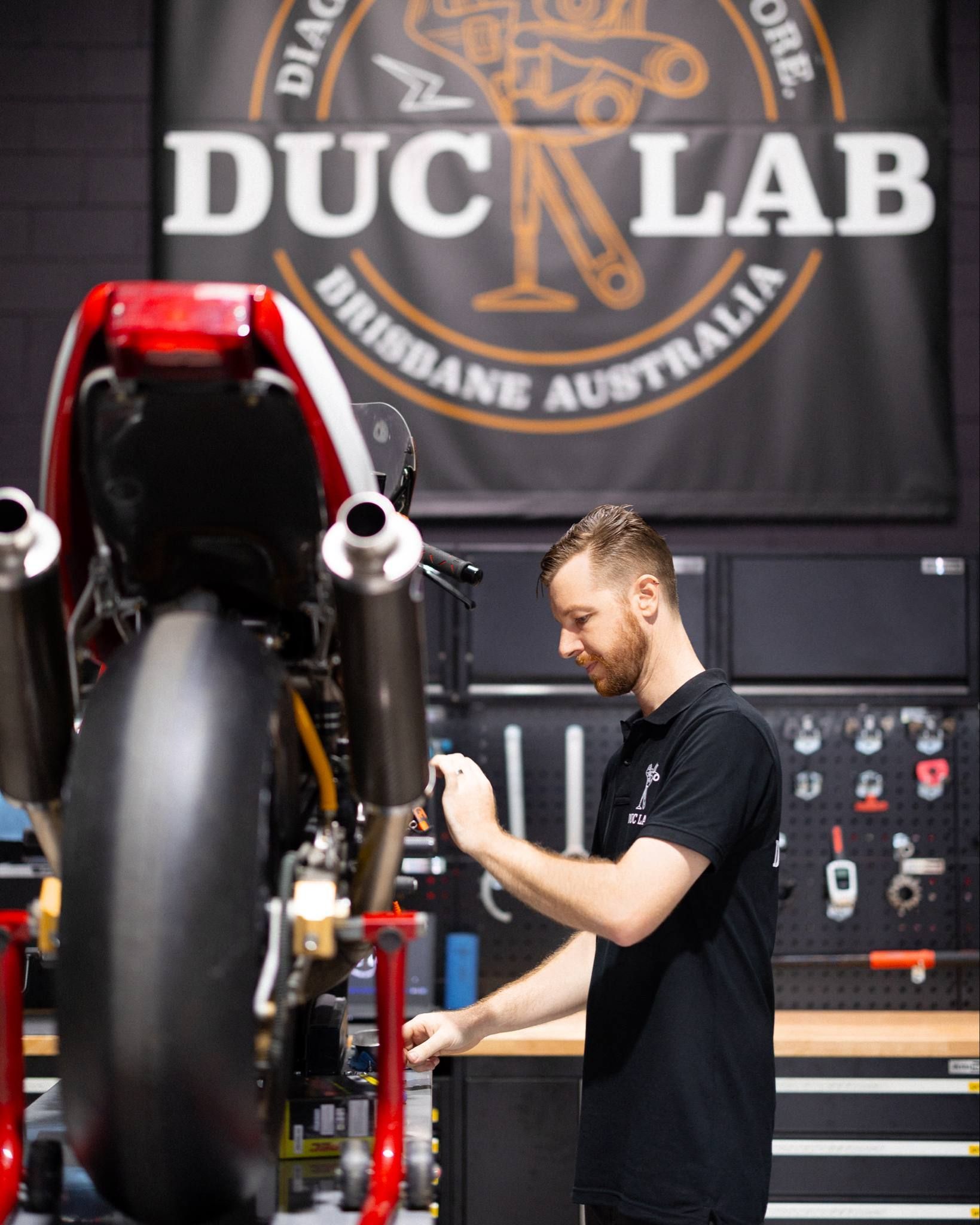 Owner Ash working on a Modern Classic Ducati motorcycle.