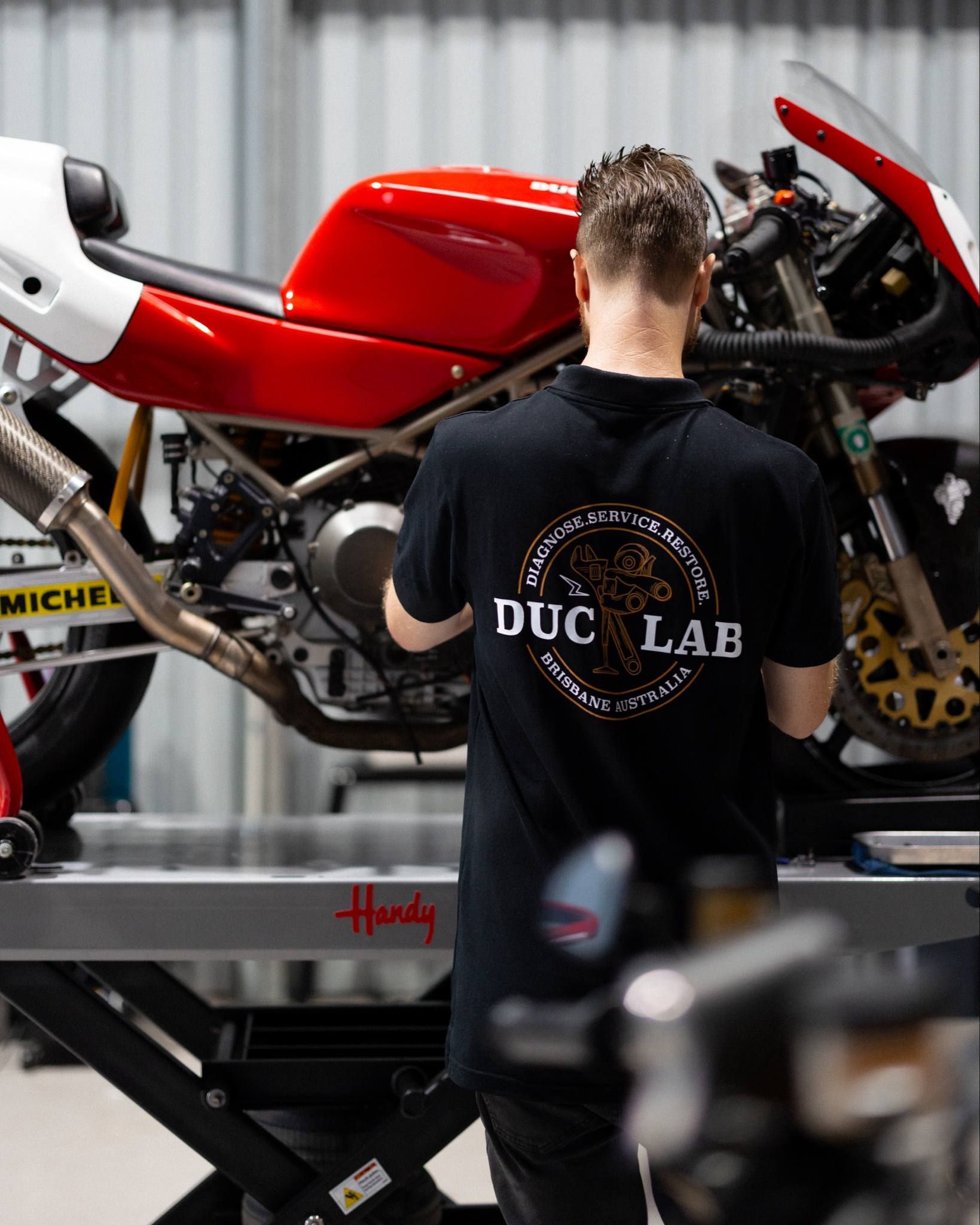 Owner Ash working on a Modern Classic Ducati motorcycle.