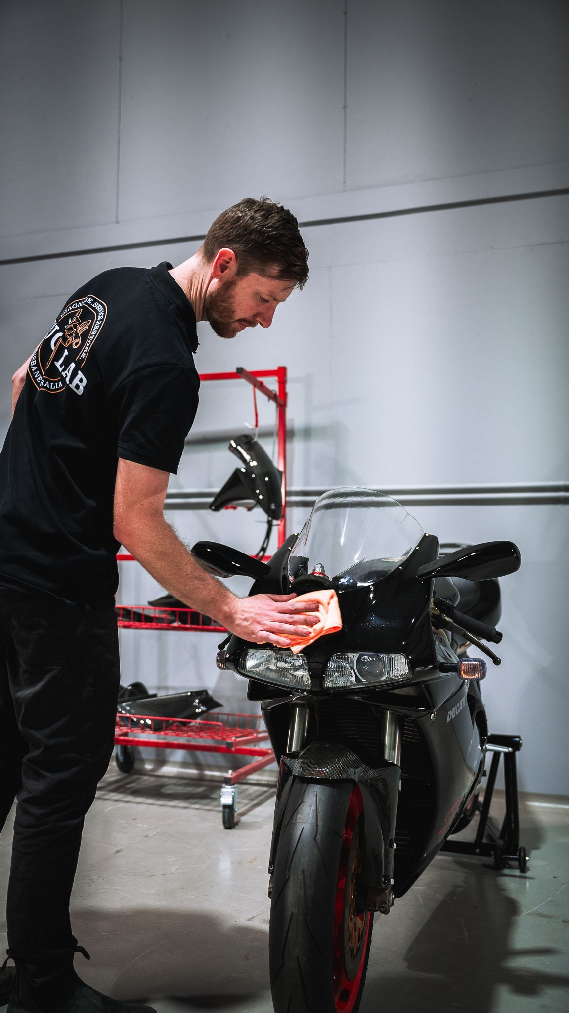 A Ducati technician is polishing a beautiful 916 Senna that was lovingly restored.