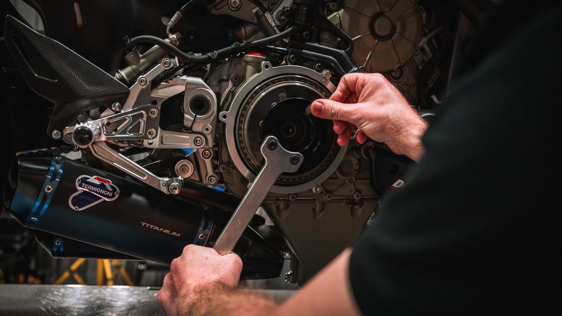 A Ducati technician changing the clutch on a motorcycle.