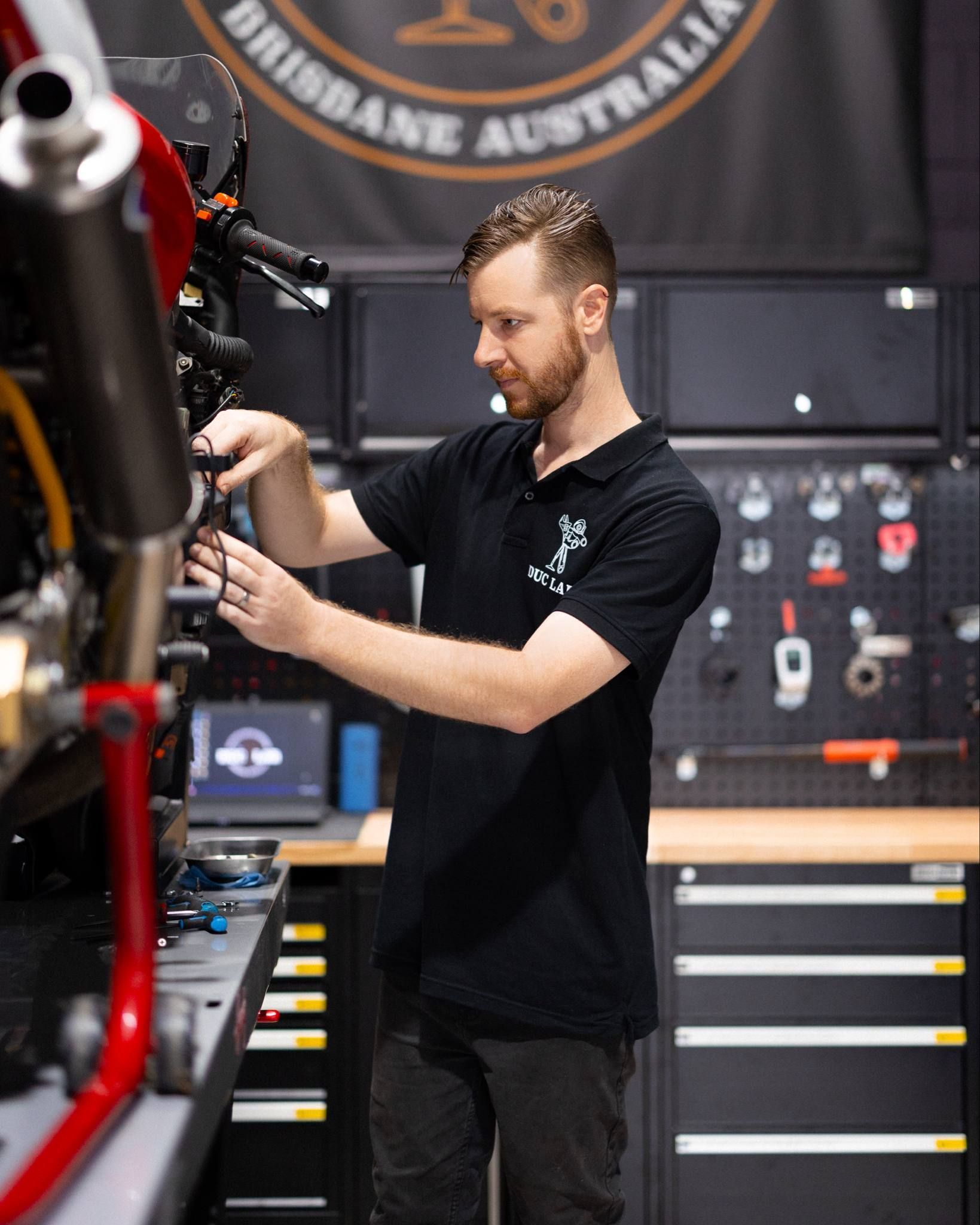 Owner Ash working on a Modern Classic Ducati motorcycle.