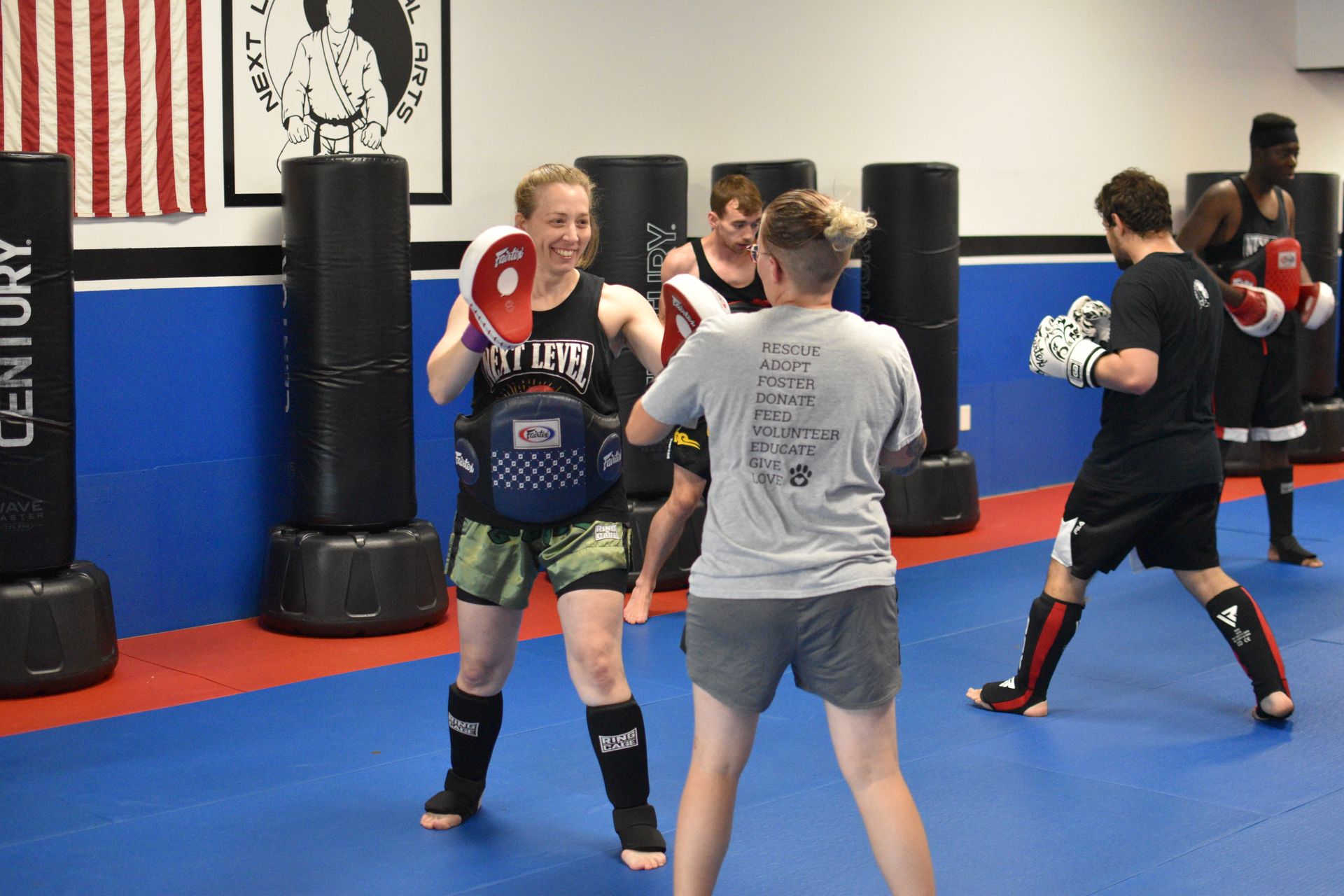 A group of people are practicing martial arts in a gym.
