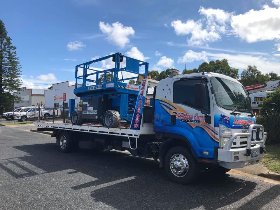 A Tow Truck is Towing a Car on the Side of the Road — Southern Cross Tilt Trays in Moranbah, QLD