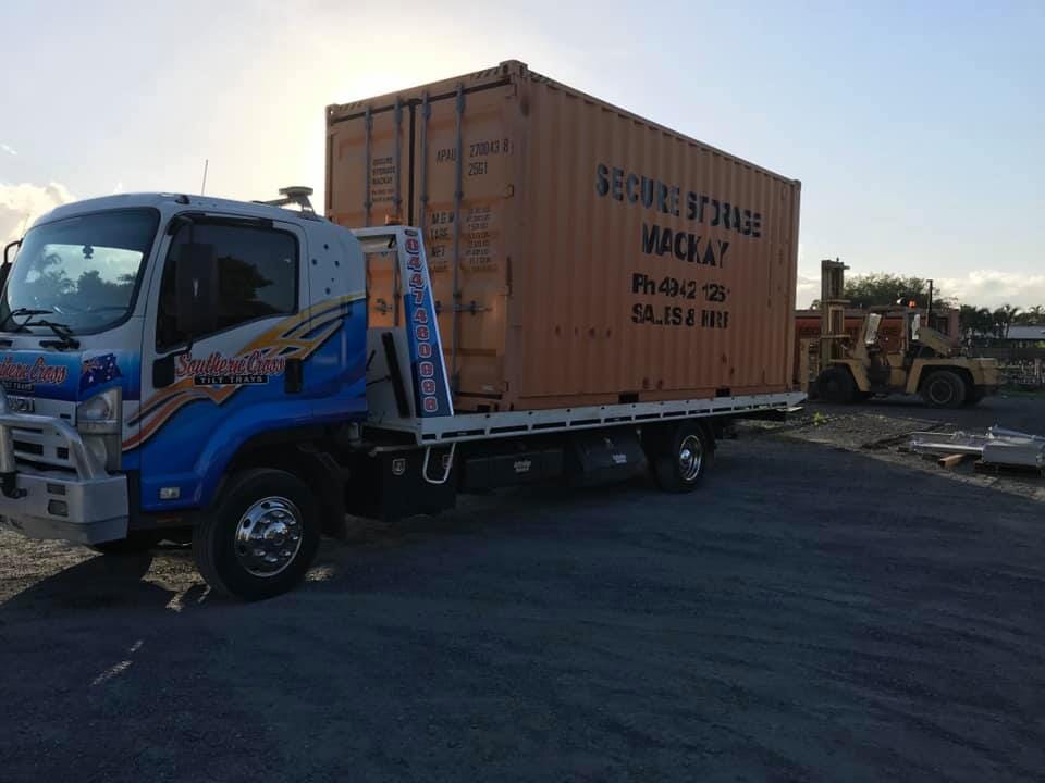 A Truck With a Container on the Back is Parked in a Parking Lot — Southern Cross Tilt Trays in Andergrove, QLD