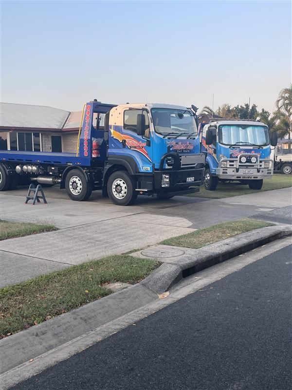 A Tow Truck With a Lift on the Back is Parked on the Side of the Road — Southern Cross Tilt Trays in Andergrove, QLD
