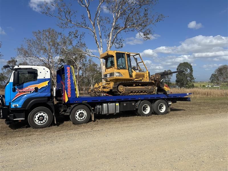 A Red Truck is Sitting on Top of a Tow Truck — Southern Cross Tilt Trays in Andergrove, QLD