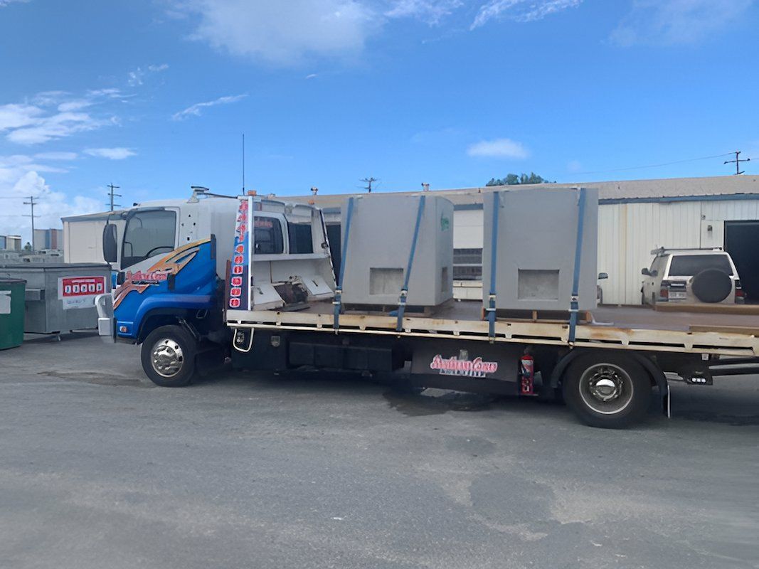 A Tow Truck With a Load on the Back is Parked — Southern Cross Tilt Trays in Andergrove, QLD