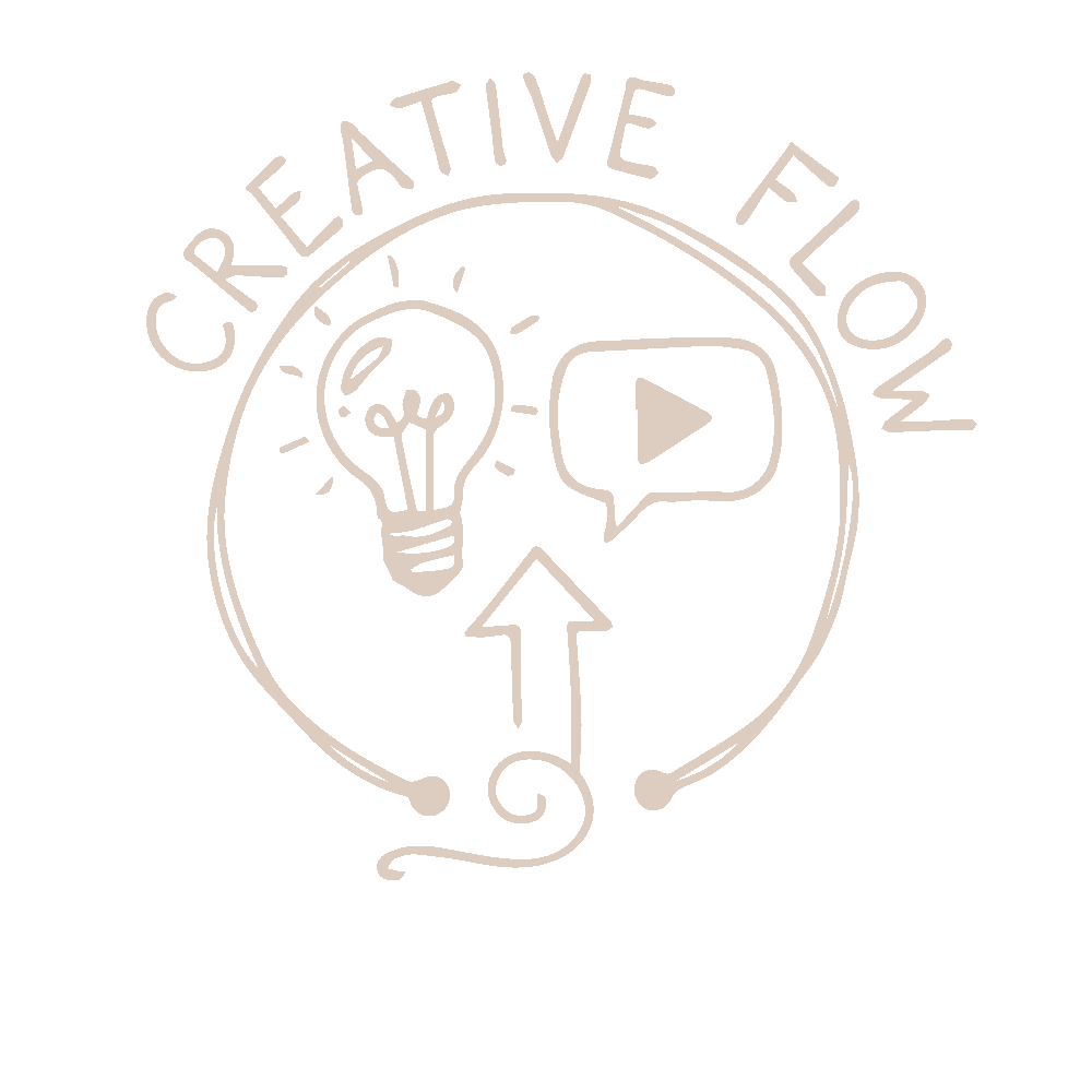 Group of people at a table, some using laptops while a man presents in a bright office.