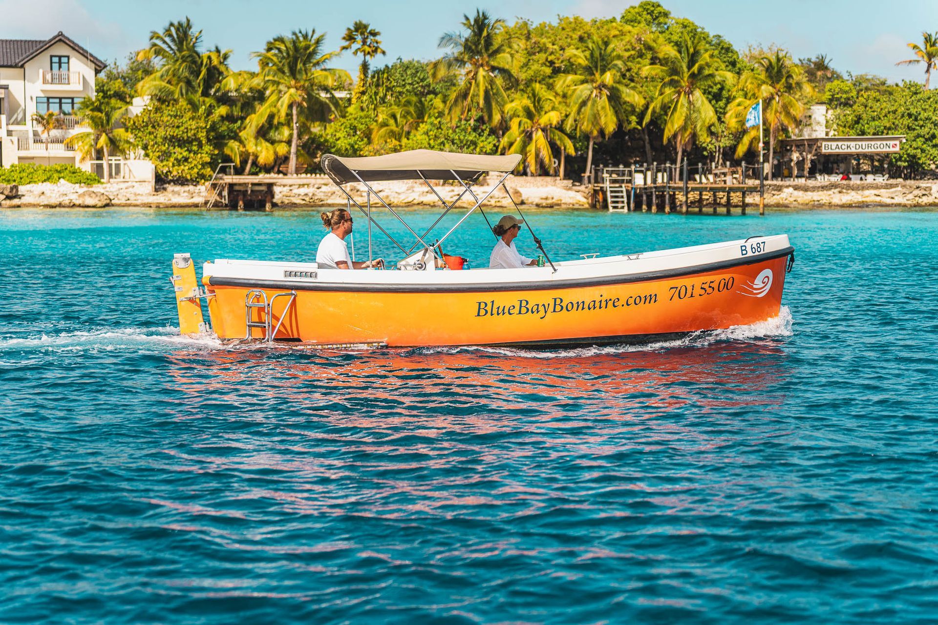 Orange Motor Boat Rentals cruising along light blue Caribbean Sea to Klein Bonaire.