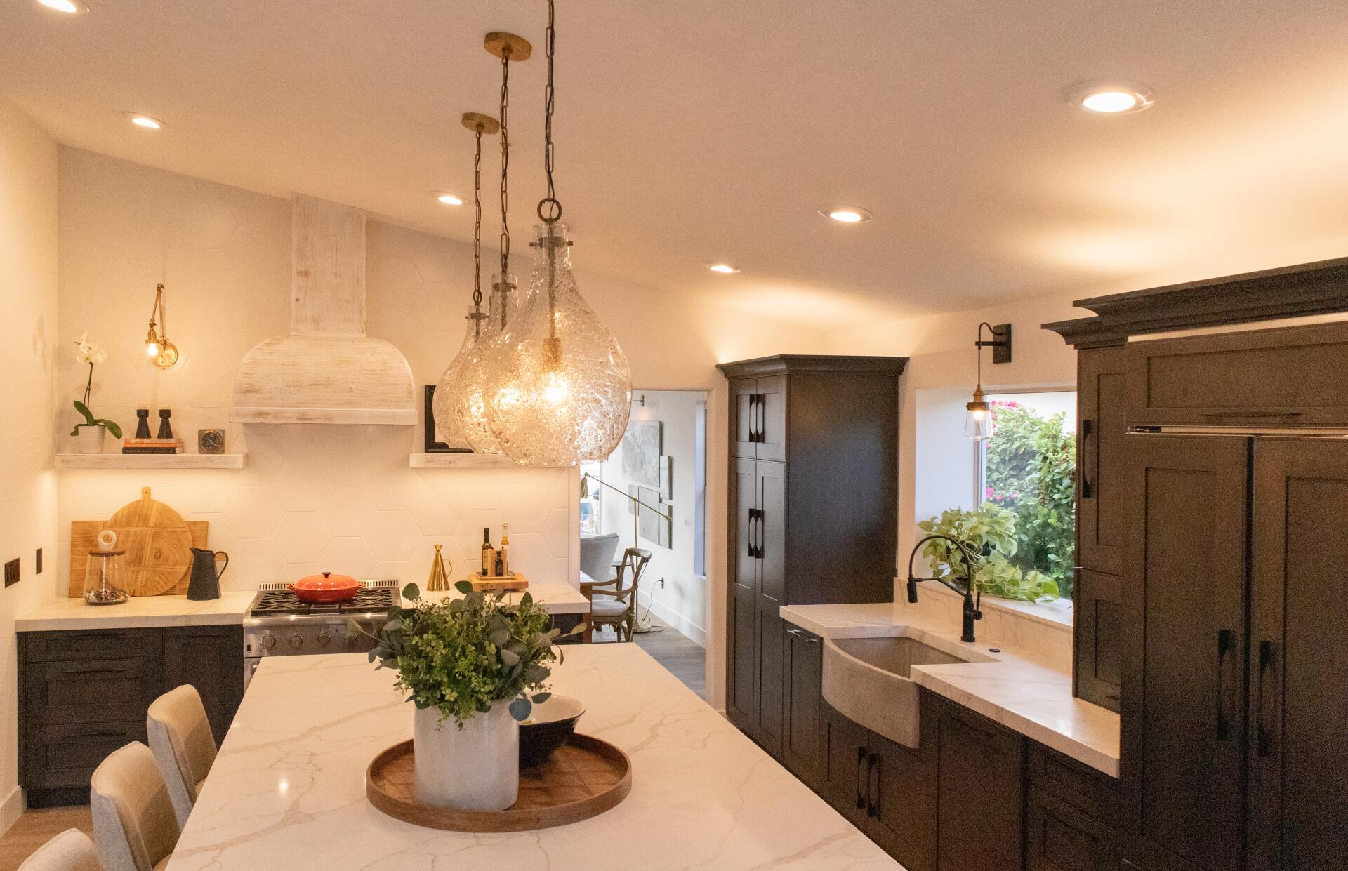 White marble countertops paired with brown wooden cabinets in a kitchen.