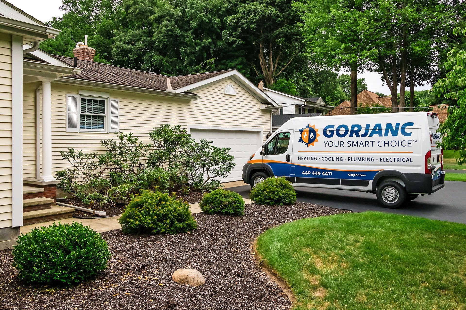 A gorjanc van is parked in front of a house.