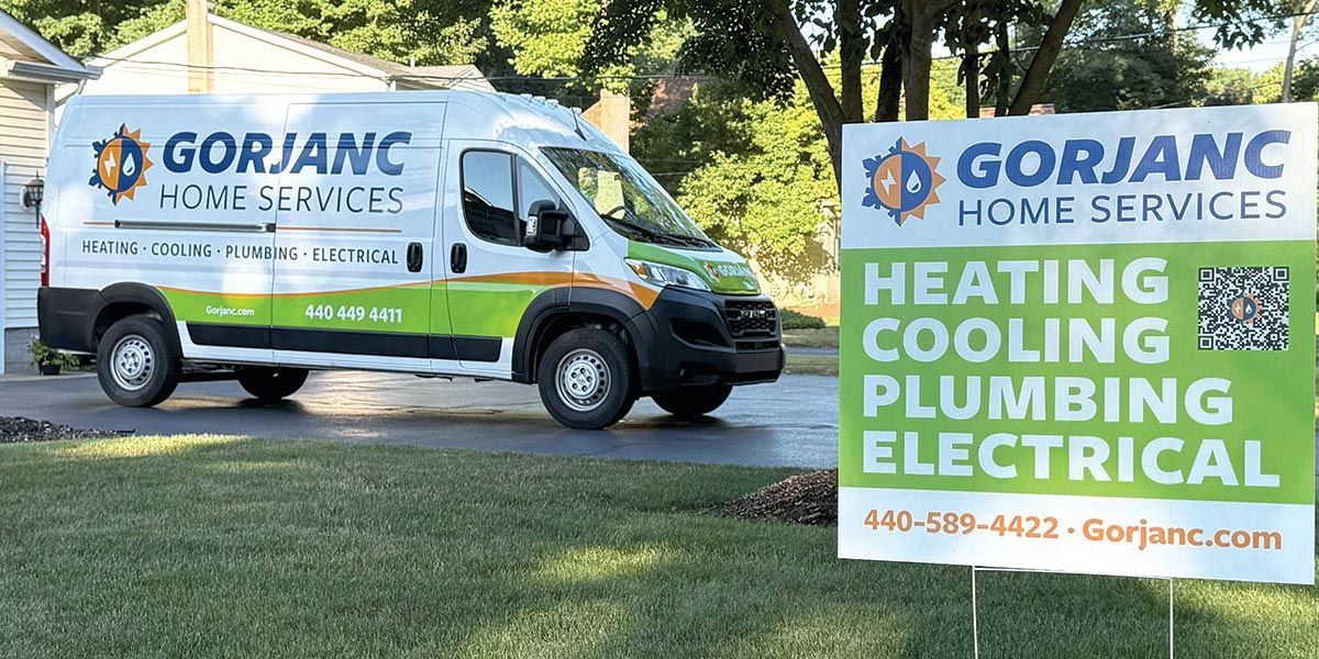 A work van parked in front of a house with a sign that says 