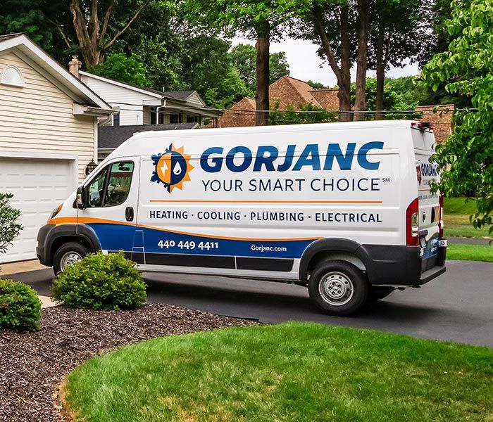 A gorjanc van is parked in front of a house