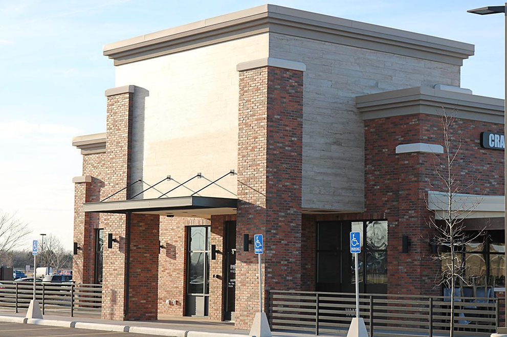 A brick building with a handicapped parking spot in front of it