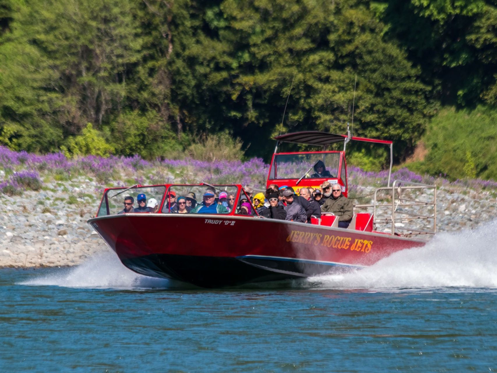 Red jetboat speeding through the river