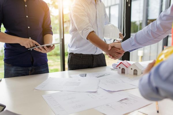 Group Of Men Are Shaking Hands — Knoxville, TN — DABZ CO LLC Electrical & Building Contractors