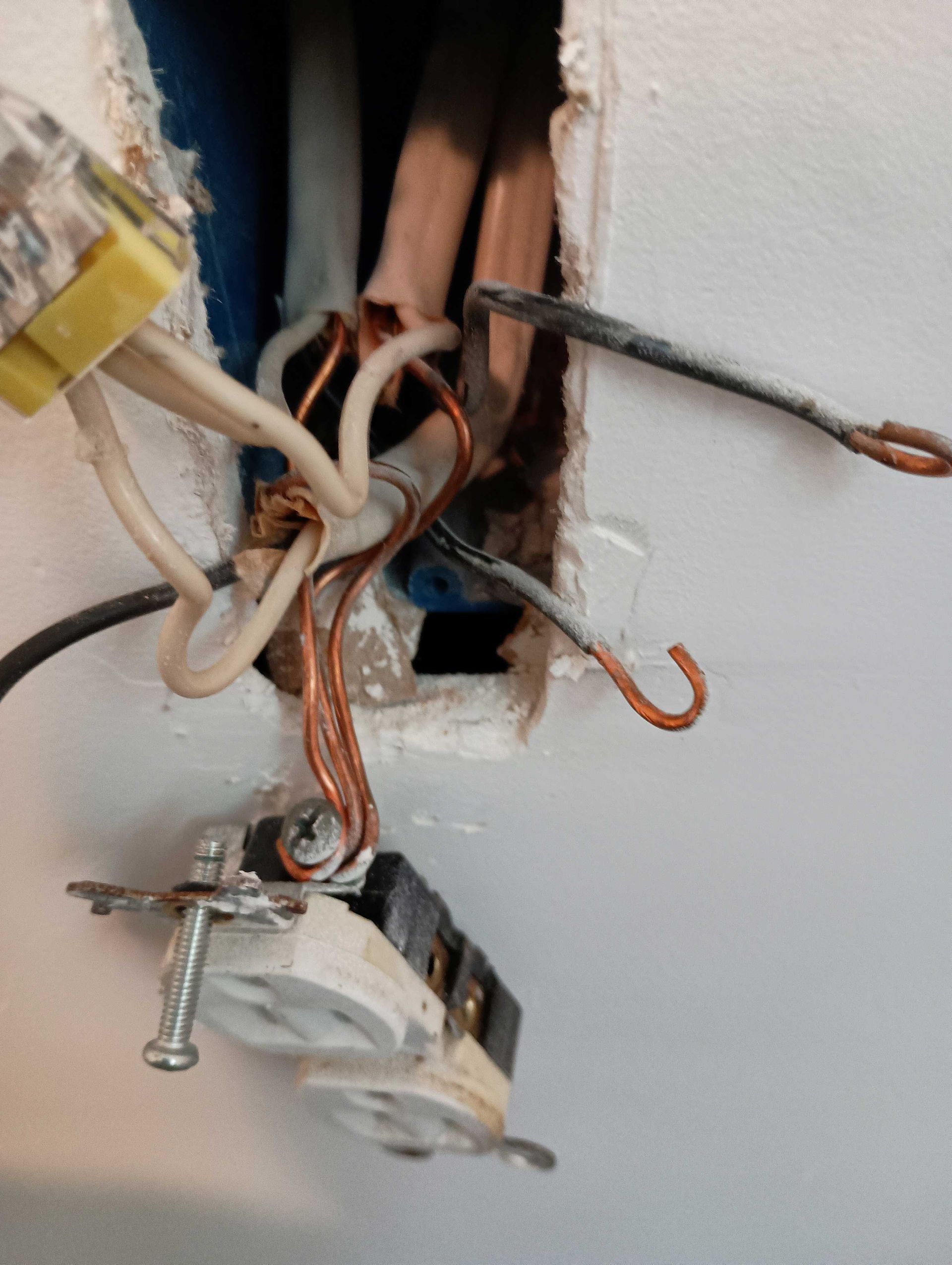 A Close Up Of An Electrical Outlet With Wires Coming Out Of It — Knoxville, TN — DABZ CO LLC Electrical & Building Contractors