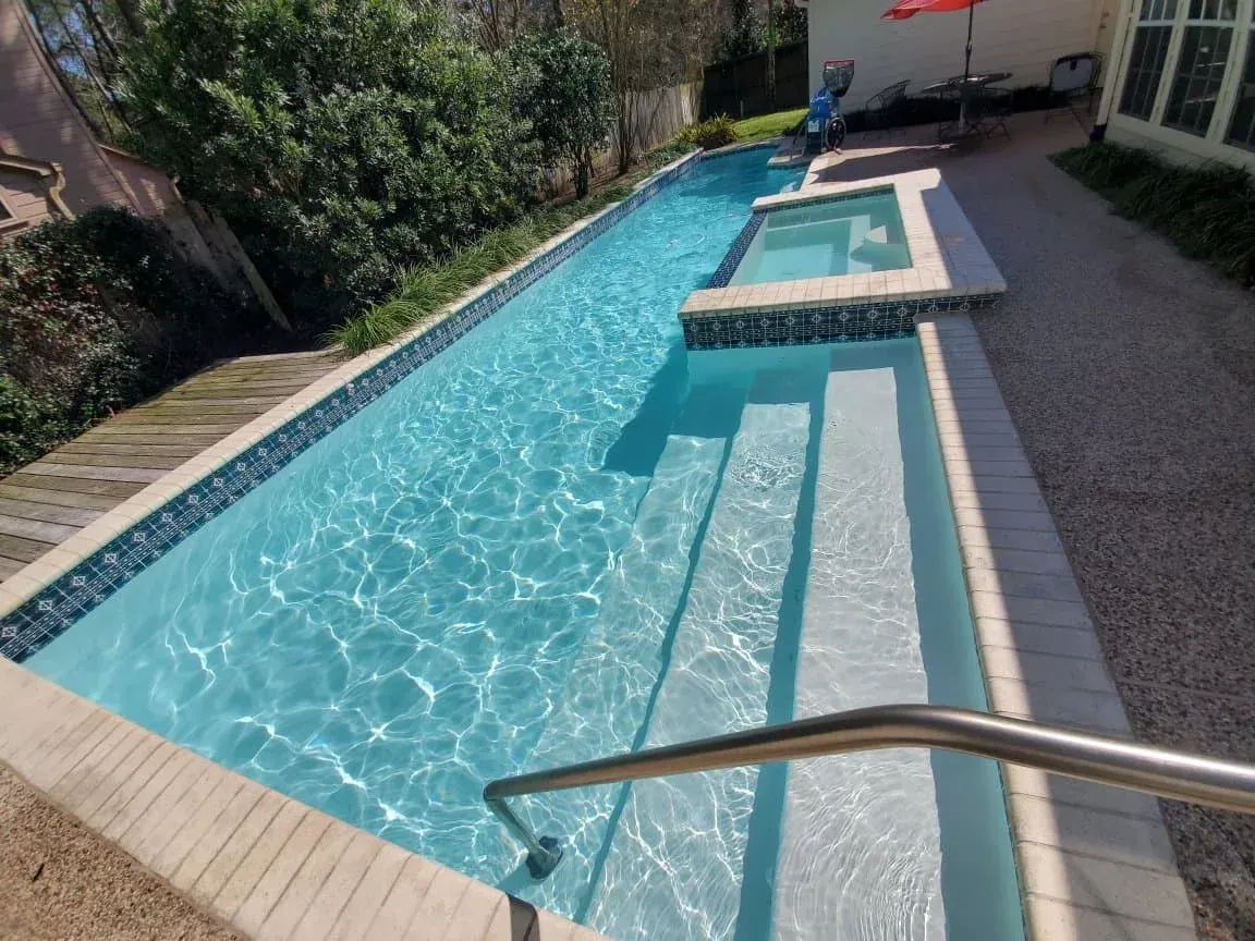 A large swimming pool with stairs leading to it