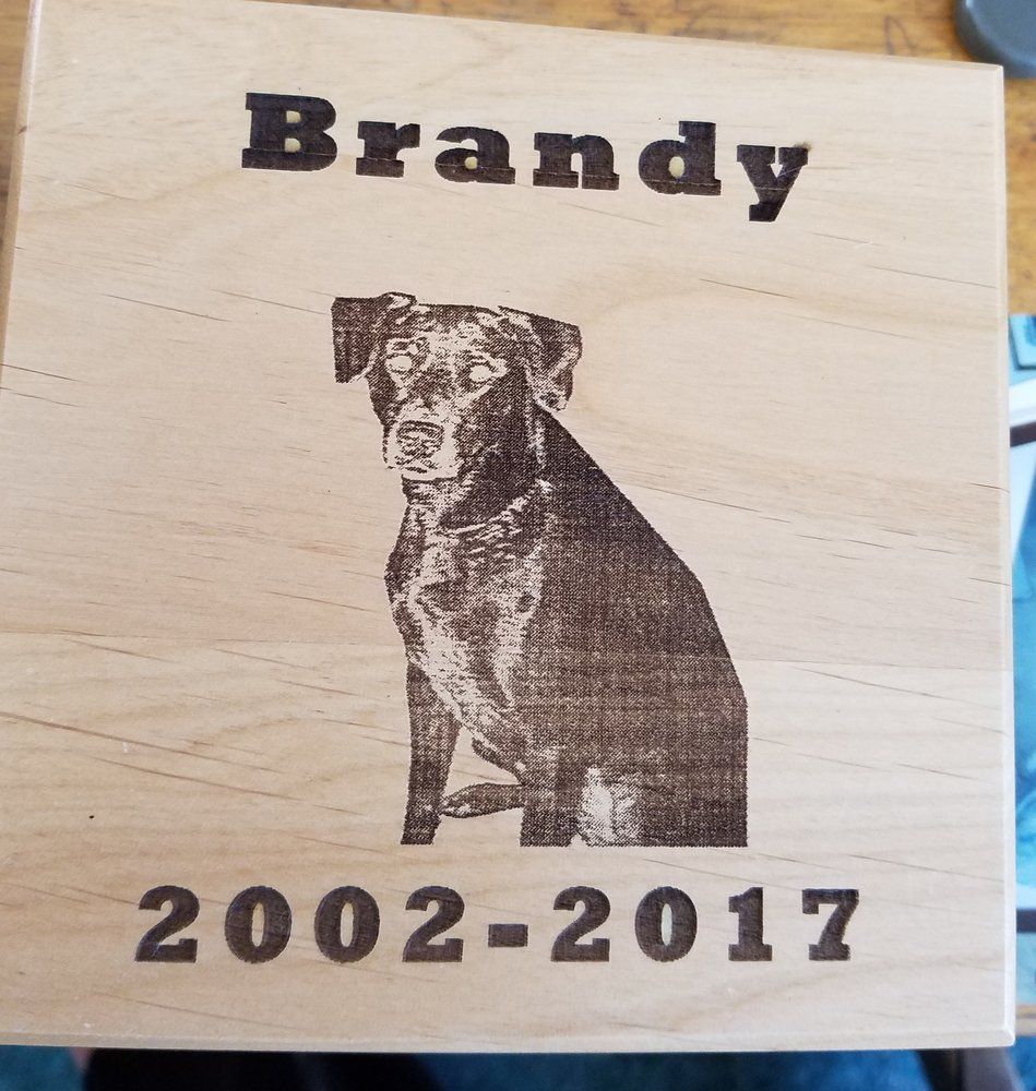 A wooden box with a picture of a dog and the name brandy 2002-2017