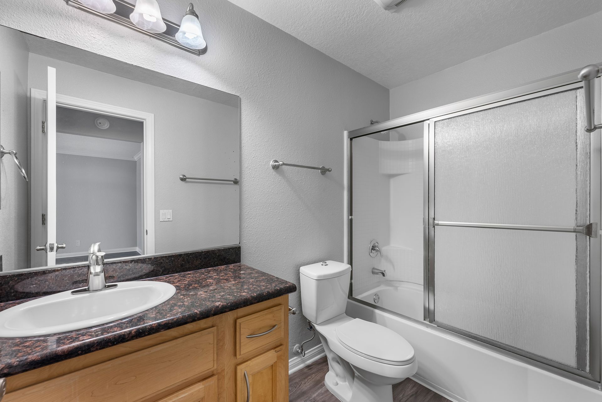 bathroom with sink, toilet, and shower