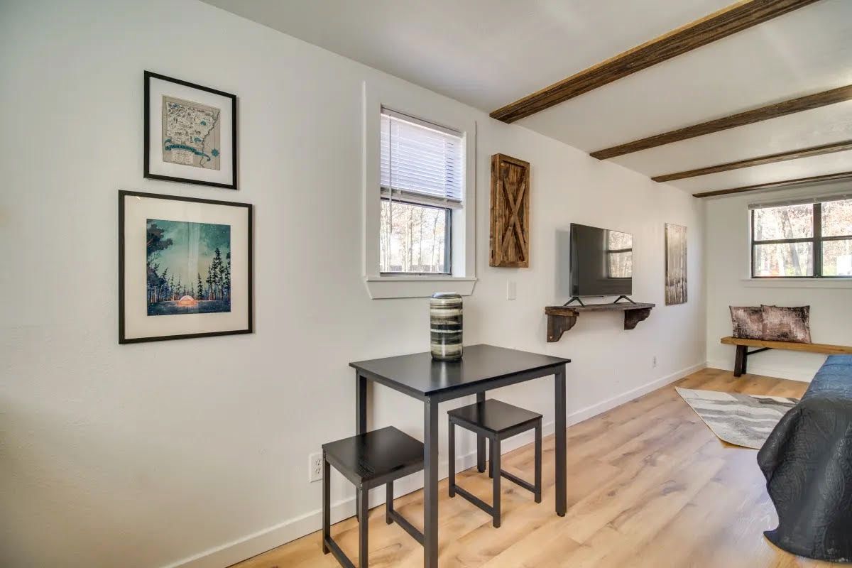 There is a small table and chairs in the middle of the room.