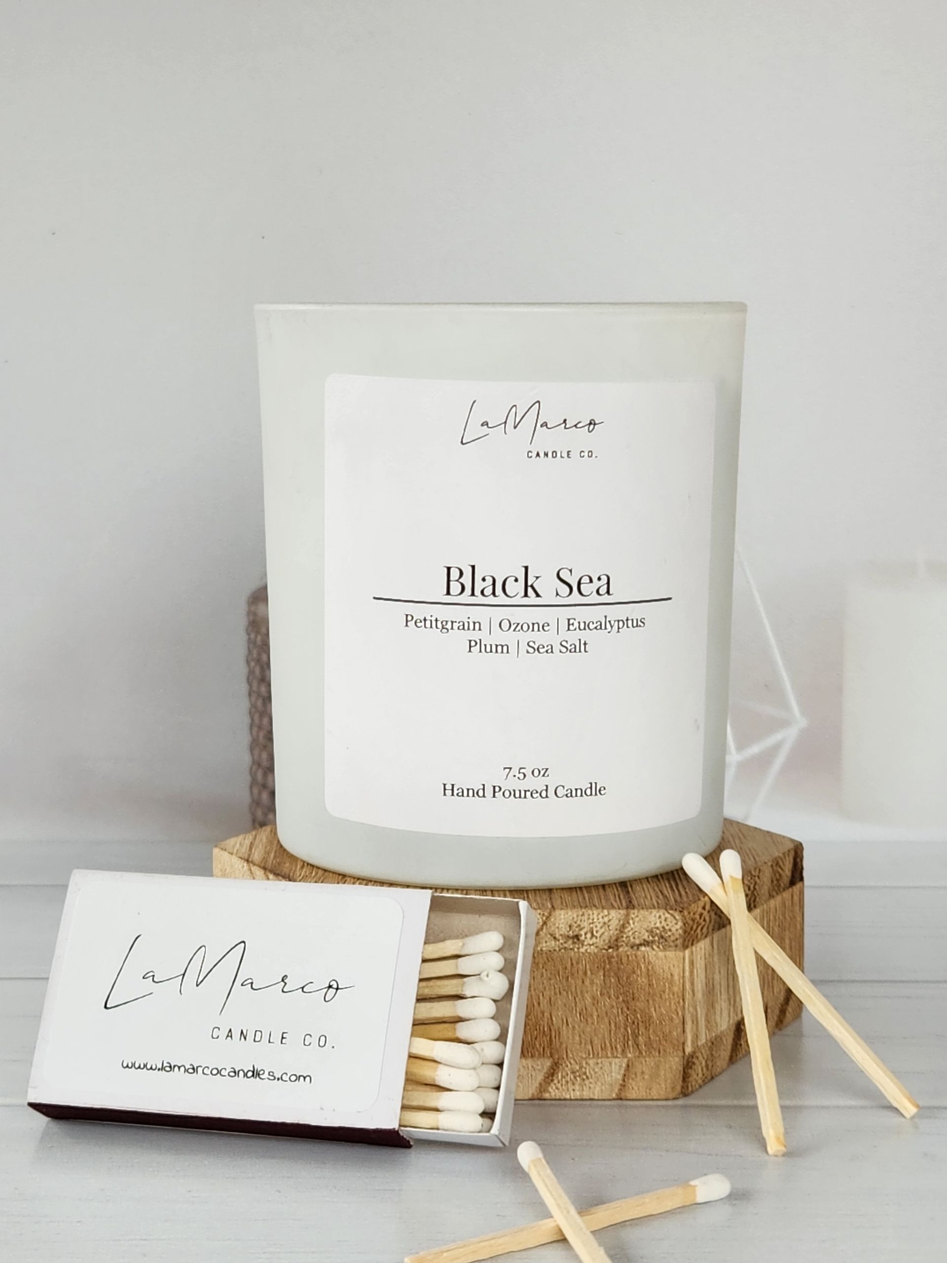 A white candle labeled 